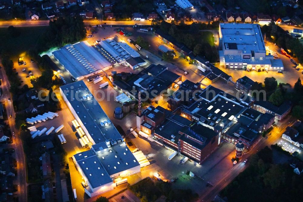 Dissen am Teutoburger Wald at night from the bird perspective: Night lighting Building and production halls on the premises of Homann Feinkost GmbH in Dissen am Teutoburger Wald in the state Lower Saxony, Germany