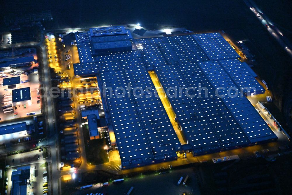 Aerial image at night Thörey - Night lighting building and production halls on the premises of the Hoermann KG in Thoerey in the state Thuringia, Germany