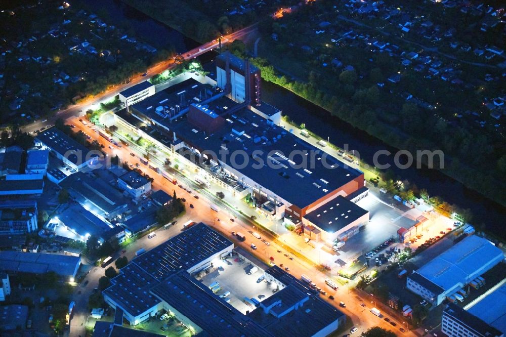 Berlin at night from above - Night lighting building and production halls on the premises of Kaffeegrosshaendler Jacobs Douwe Egberts in Berlin, Germany