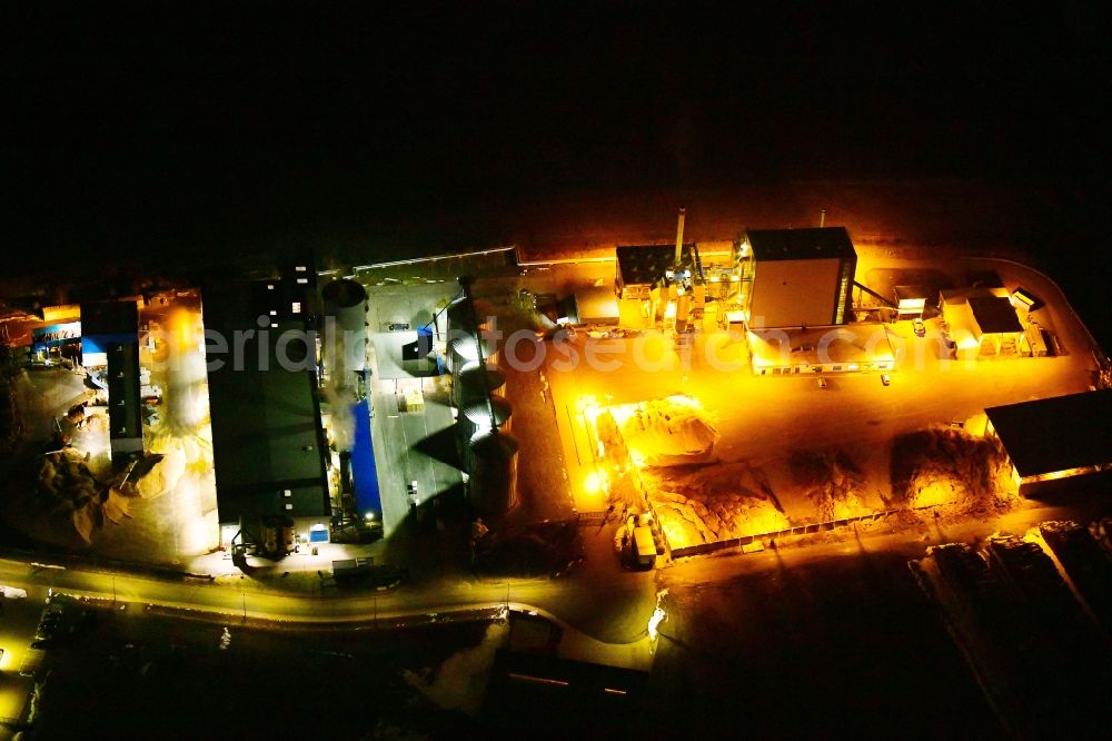 Erndtebrück at night from above - Night lighting building and production halls on the premises of NRW Pellets GmbH in Erndtebrueck in the state North Rhine-Westphalia, Germany