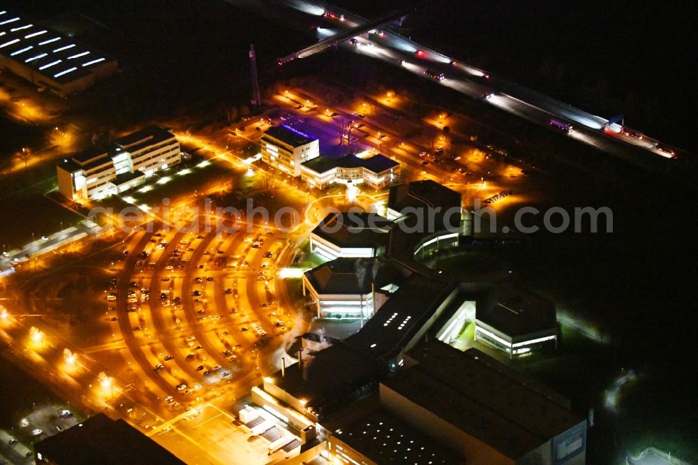 Aerial photograph at night Barleben - Night lighting building and production halls on the premises of Salutas Pharma GmbH on Otto-von-Guericke-Allee in the district Suelzegrund in Barleben in the state Saxony-Anhalt, Germany
