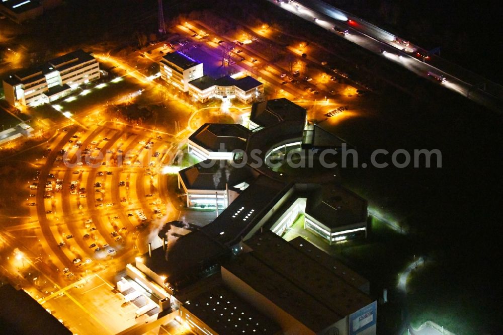 Aerial image at night Barleben - Night lighting building and production halls on the premises of Salutas Pharma GmbH on Otto-von-Guericke-Allee in the district Suelzegrund in Barleben in the state Saxony-Anhalt, Germany