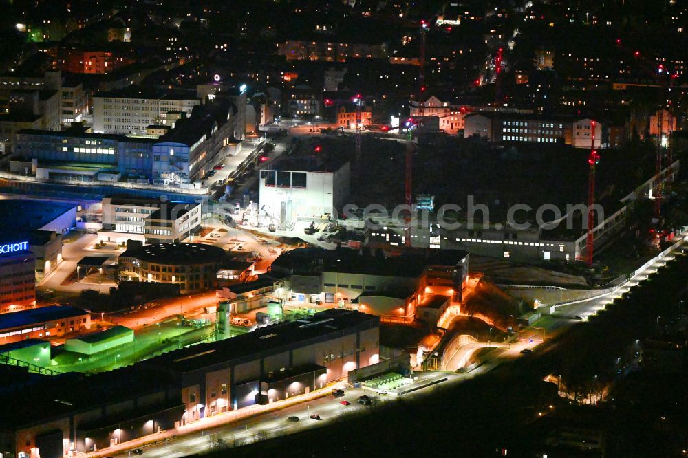 Aerial photograph at night Jena - Night lighting building and production halls on the premises SCHOTT Technical Glass Solutions GmbH on street Otto-Schott-Strasse in the district Lichtenhain in Jena in the state Thuringia, Germany