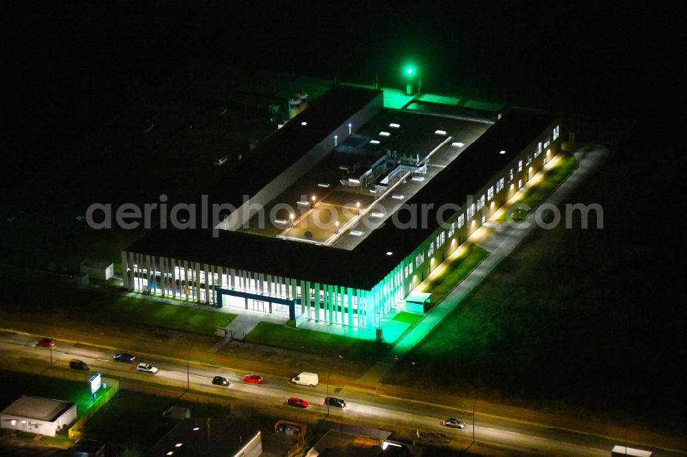 Aerial image at night Berlin - Night lighting building and production halls on the premises of Swissbit Germany AG in CleanTech Business Park in the district Marzahn in Berlin, Germany