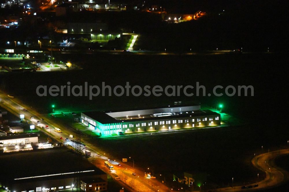 Berlin at night from the bird perspective: Night lighting building and production halls on the premises of Swissbit Germany AG in CleanTech Business Park in the district Marzahn in Berlin, Germany