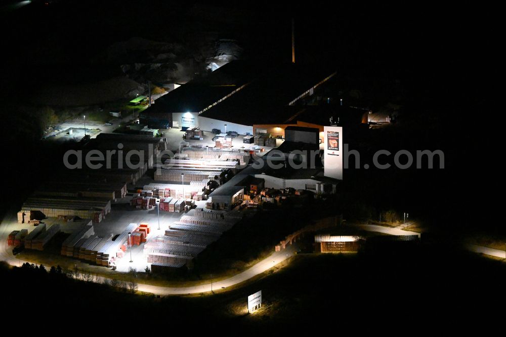Eisenberg at night from the bird perspective: Night lighting building and production halls on the premises of Wienerberger GmbH in Eisenberg in the state Thuringia, Germany