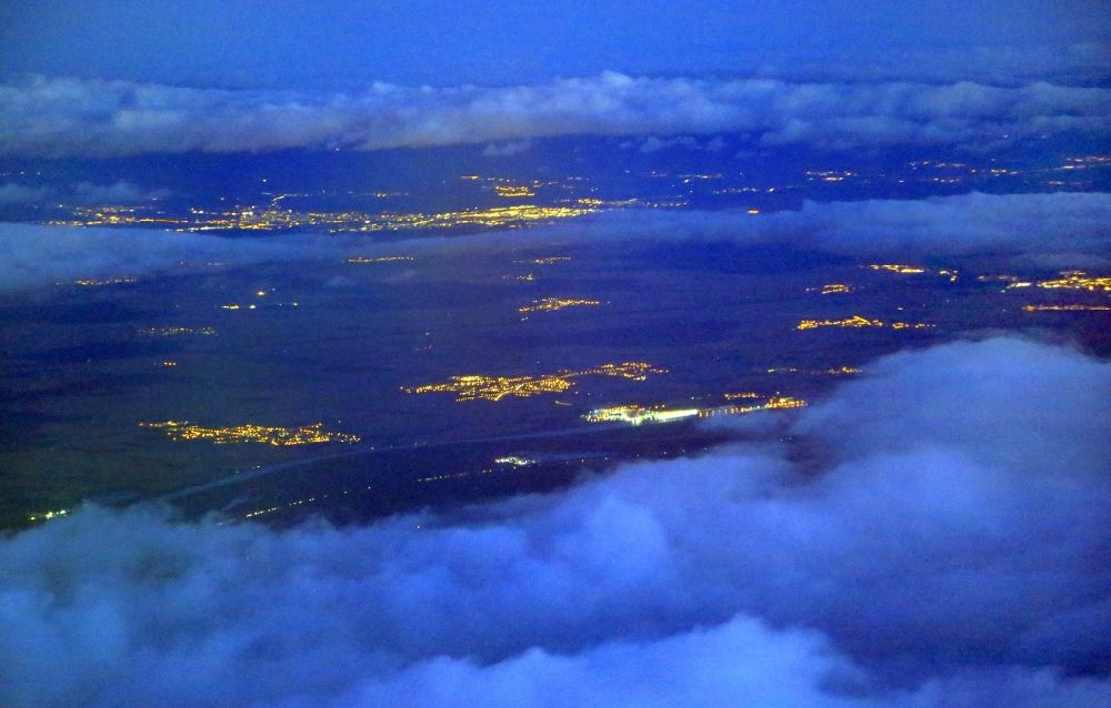 Aerial image at night Fessenheim - Night lighting weather situation with cloud formation and light reflections of the towns and villages in the Rhine valley at Fessenheim and Colmar in Grand Est, France