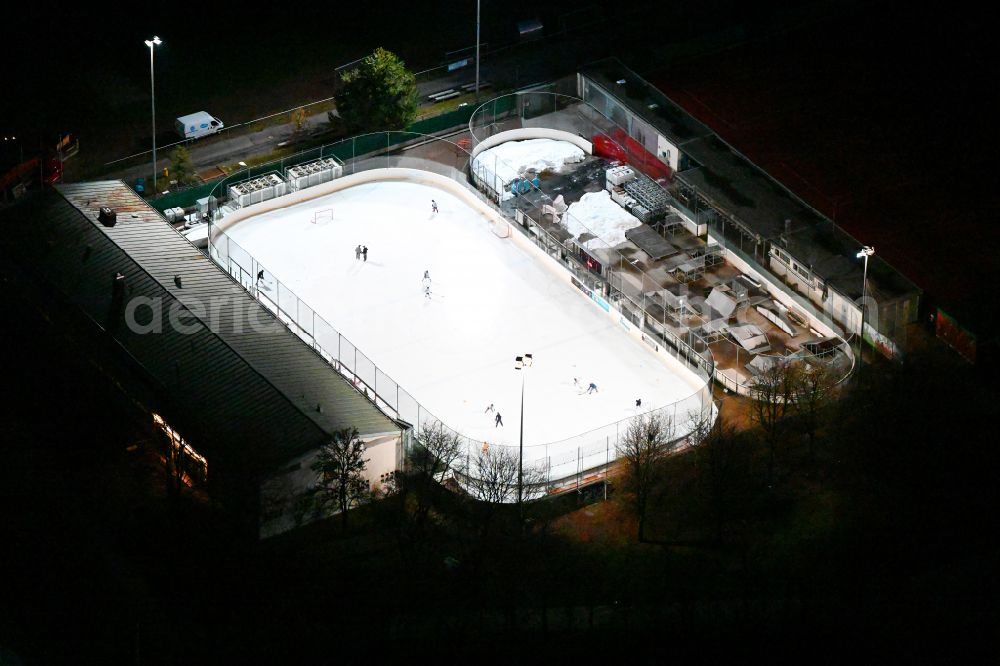 Aerial image at night München - Night lighting wintry white shining ice covering Eis- and Funsportzentrum West on street Agnes-Bernauer-Strasse in Munich in the state Bavaria, Germany