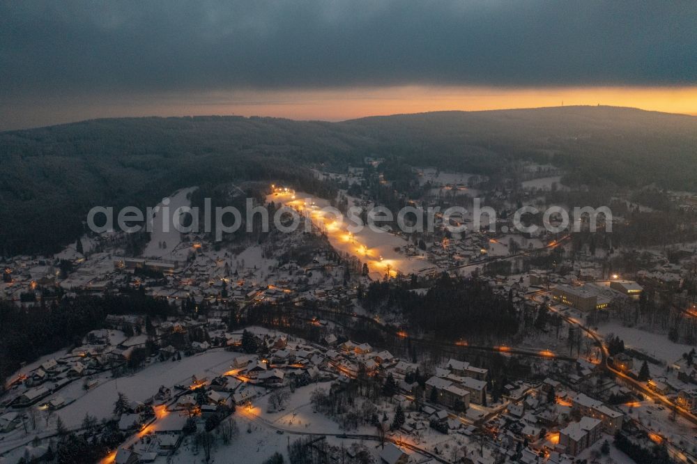 Aerial photograph at night Smrzovka - Night lighting wintry snowy town of the streets and houses of the residential areas in Smrzovka in Liberecky kraj, Czech Republic