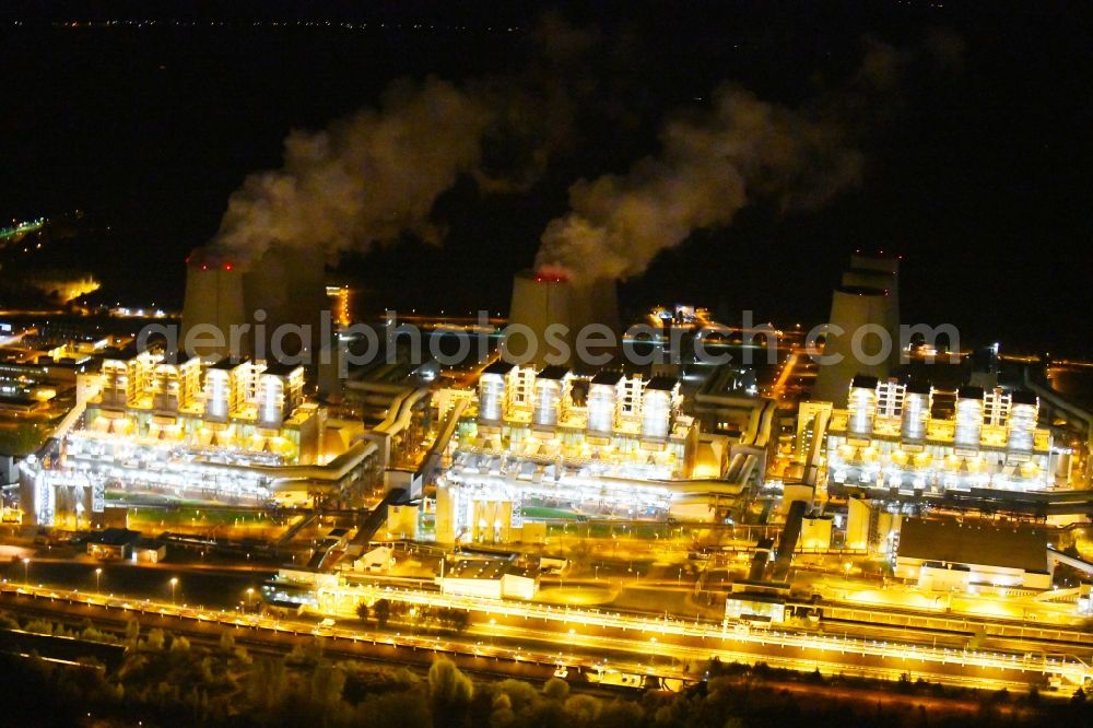 Teichland at night from the bird perspective: Night lighting clouds of exhaust gas in the cooling towers of the power plant Jaenschwalde, a lignite-fired thermal power plant in southeastern Brandenburg. Power plant operator is to Vattenfall Europe belonging Vattenfall Europe Generation AG, which emerged from VEAG