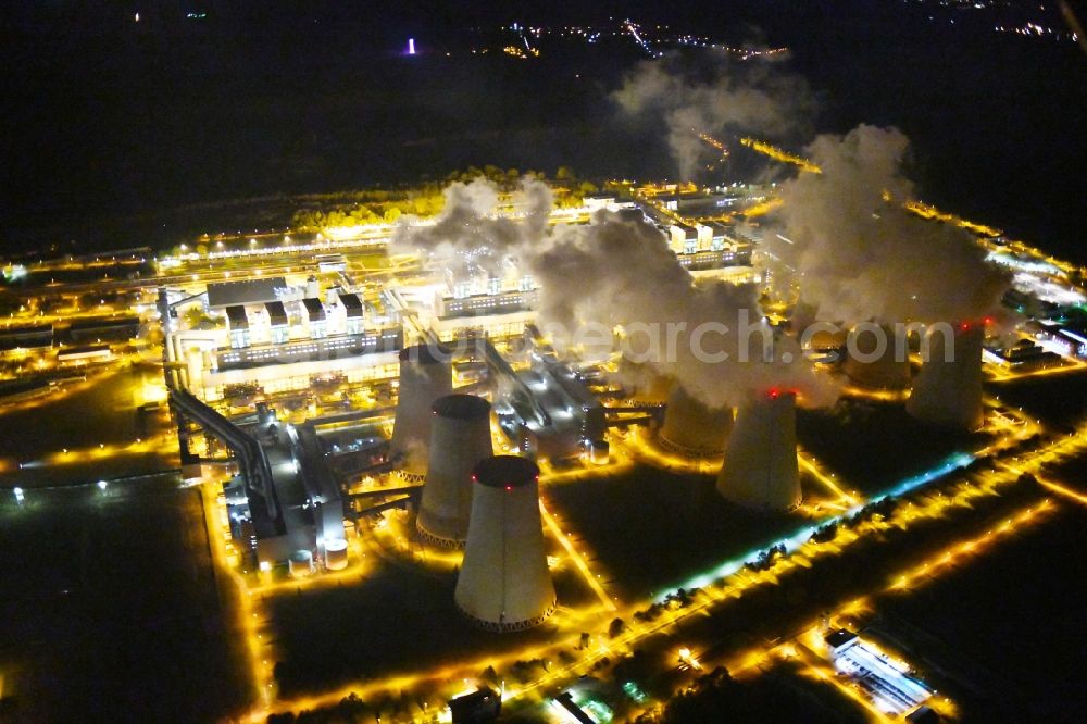 Aerial image at night Teichland - Night lighting clouds of exhaust gas in the cooling towers of the power plant Jaenschwalde, a lignite-fired thermal power plant in southeastern Brandenburg. Power plant operator is to Vattenfall Europe belonging Vattenfall Europe Generation AG, which emerged from VEAG