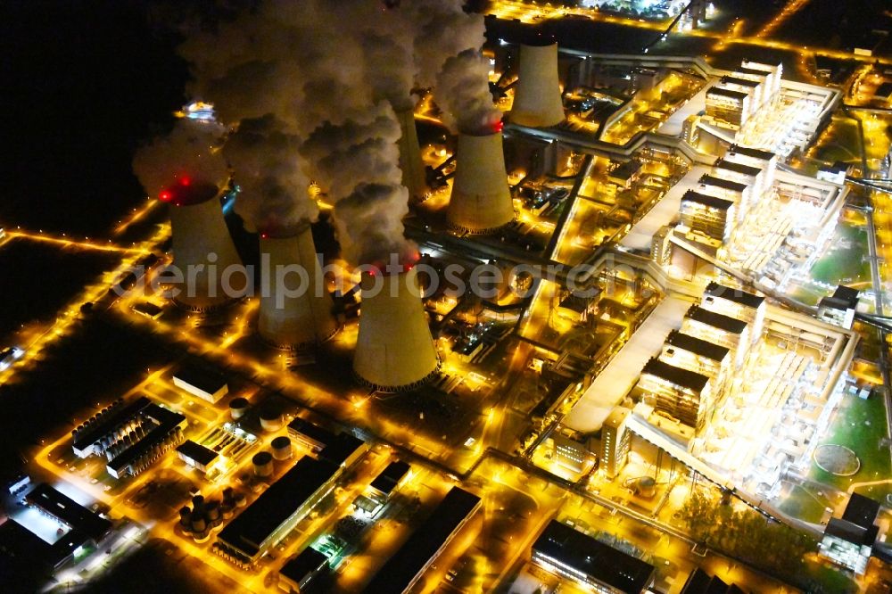 Teichland at night from the bird perspective: Night lighting clouds of exhaust gas in the cooling towers of the power plant Jaenschwalde, a lignite-fired thermal power plant in southeastern Brandenburg. Power plant operator is to Vattenfall Europe belonging Vattenfall Europe Generation AG, which emerged from VEAG