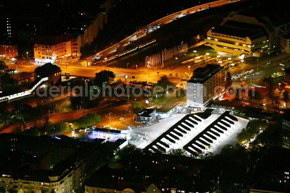 Berlin at night from the bird perspective: Night lighting central Bus Station for Public Transportation on Masurenallee in the district Westend in Berlin, Germany