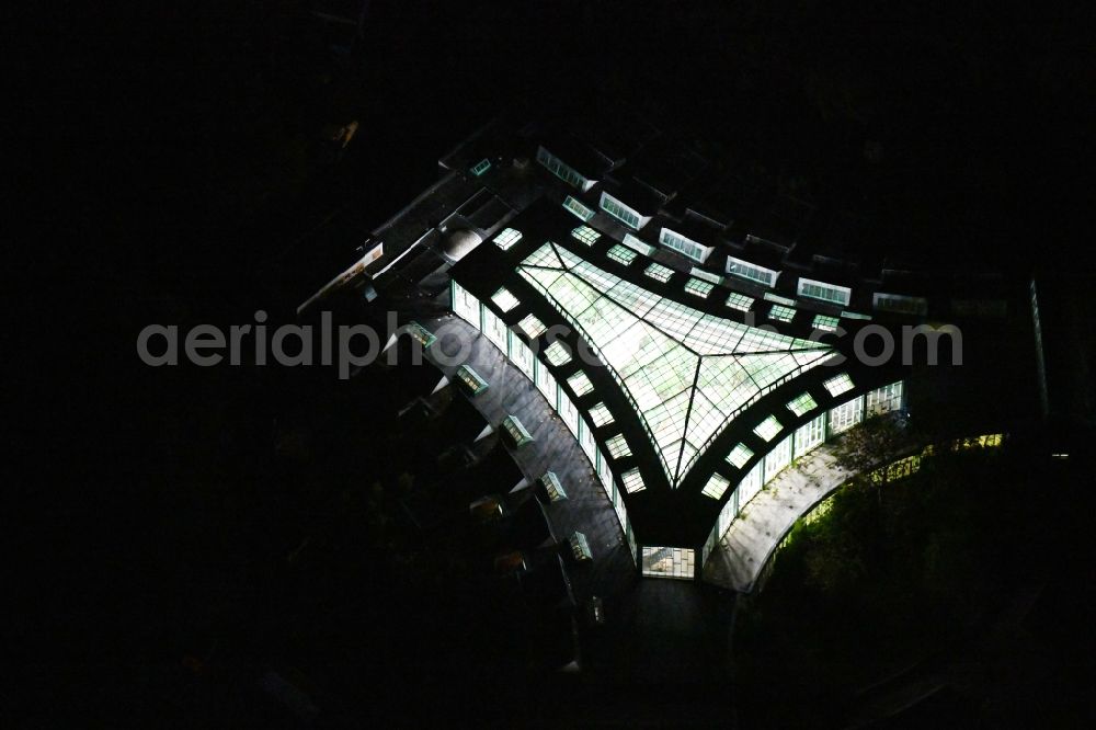 Aerial image at night Berlin - Night lighting zoo grounds at the Alfred Brehm House in Tierpark in the district of Friedrichsfelde in Berlin, Germany