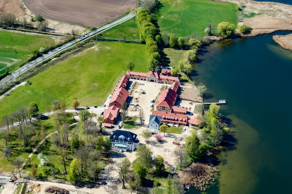 Malente from the bird's eye view: Construction sites for redevelopment, renovation to expansion of the buildings and manor house of the estate Gut Immenhof on the banks of the Kellersee in Malente in the state Schleswig-Holstein, Germany