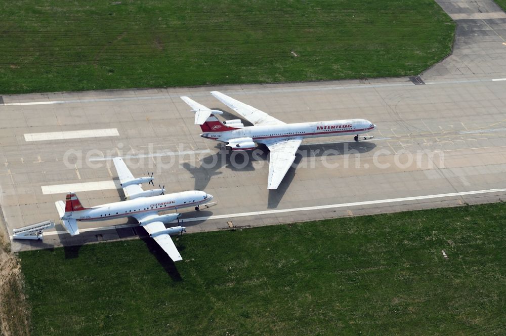 Leipzig Schkeuditz from above - Decommissioned passenger aircraft Ilyushin IL18 and IL-62 of the former East German airline INTERFLUG on the remnants of the old airstrip at Leipzig - Schkeuditz in Saxony