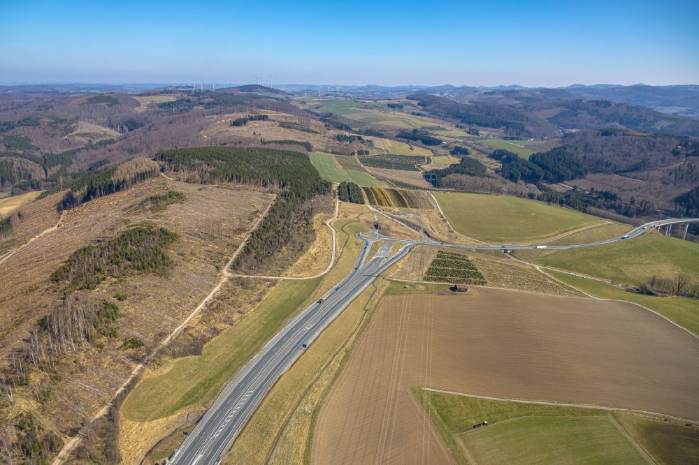 Aerial image Nuttlar - Routing and lanes in the course of the exit and access to the motorway junction of the BAB A46 with a roundabout on the federal road B7 in Nuttlar in the Sauerland in the state of North Rhine-Westphalia, Germany