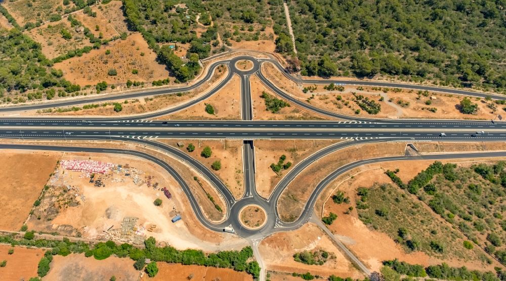 Campos from the bird's eye view: Route and lanes in the course of the exit and access of the motorway junction of the Ma-19 at the Cami de Cas Rubins in Campos in Islas Baleares, Spain