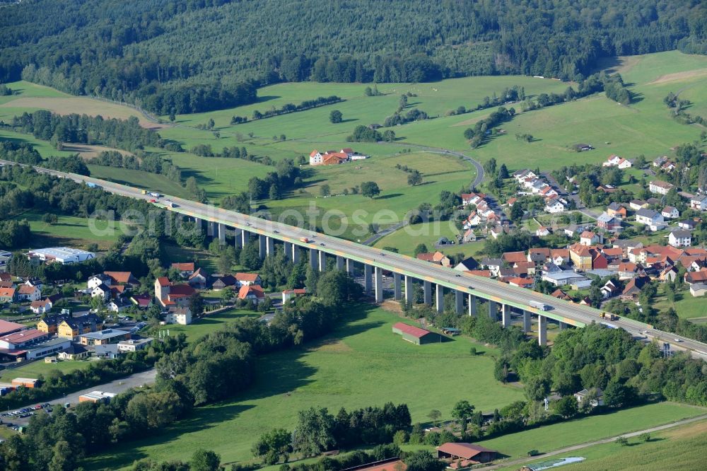 Aerial photograph Uttrichshausen - Routing and traffic lanes over the highway bridge in the motorway A7 in Uttrichshausen in the state Hesse