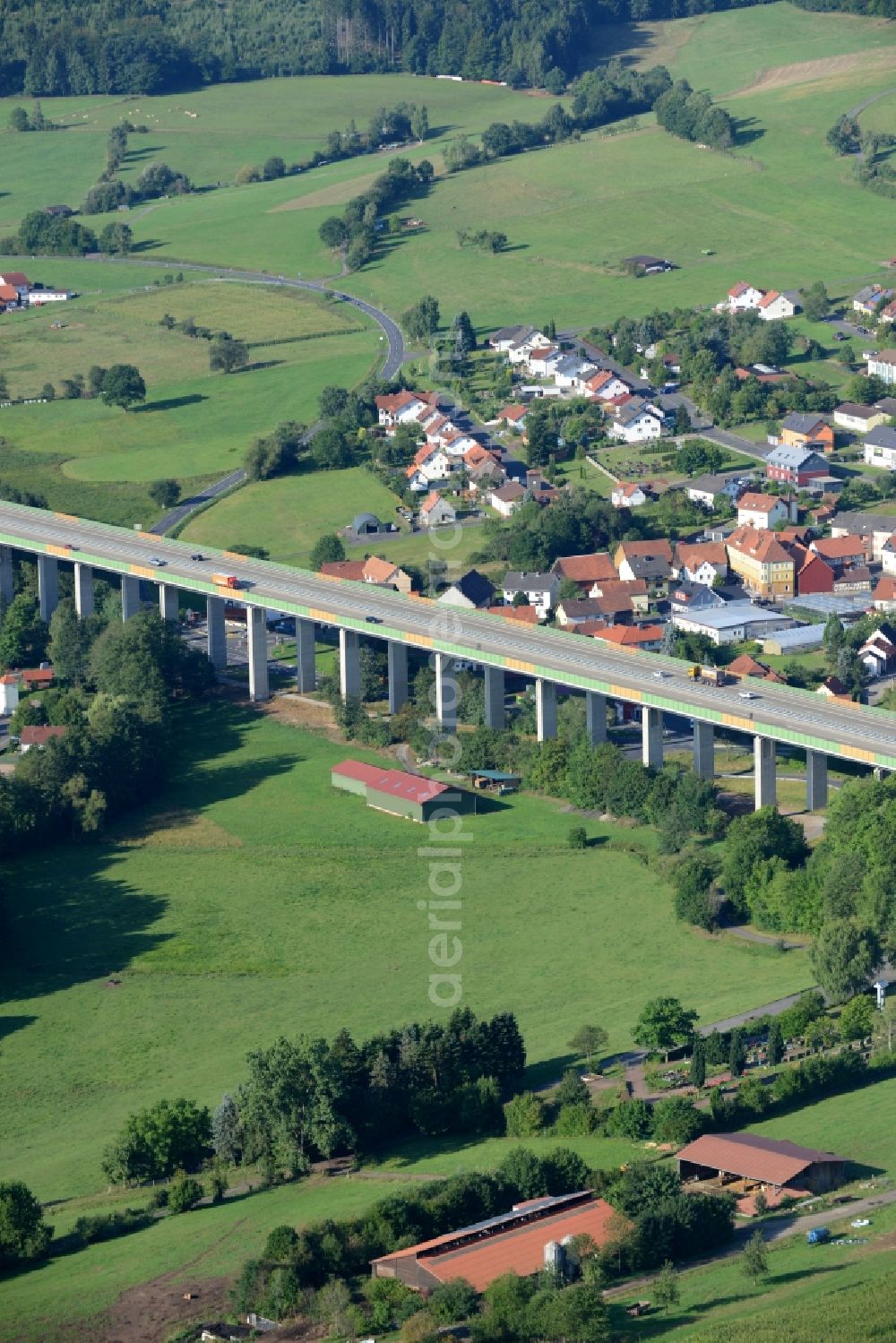 Aerial photograph Uttrichshausen - Routing and traffic lanes over the highway bridge in the motorway A7 in Uttrichshausen in the state Hesse