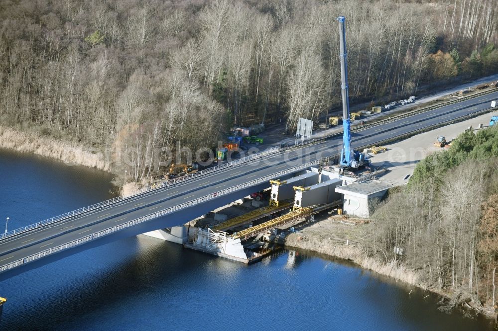 Petersdorf from the bird's eye view: Routing and traffic lanes over the highway bridge in the motorway A 19 and new construction site in Petersdorf in the state Mecklenburg - Western Pomerania