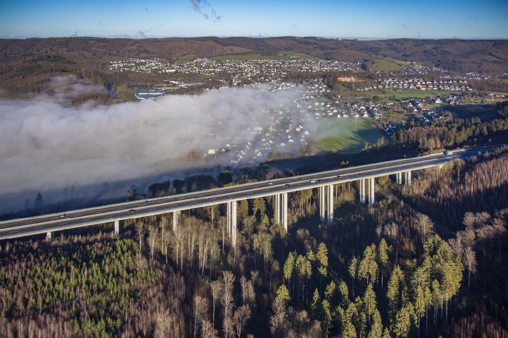 Arnsberg from the bird's eye view: Fog clouds on routing and traffic lanes over the highway bridge in the motorway A 46 - Talbruecke Huenenburg in Arnsberg at Ruhrgebiet in the state North Rhine-Westphalia, Germany