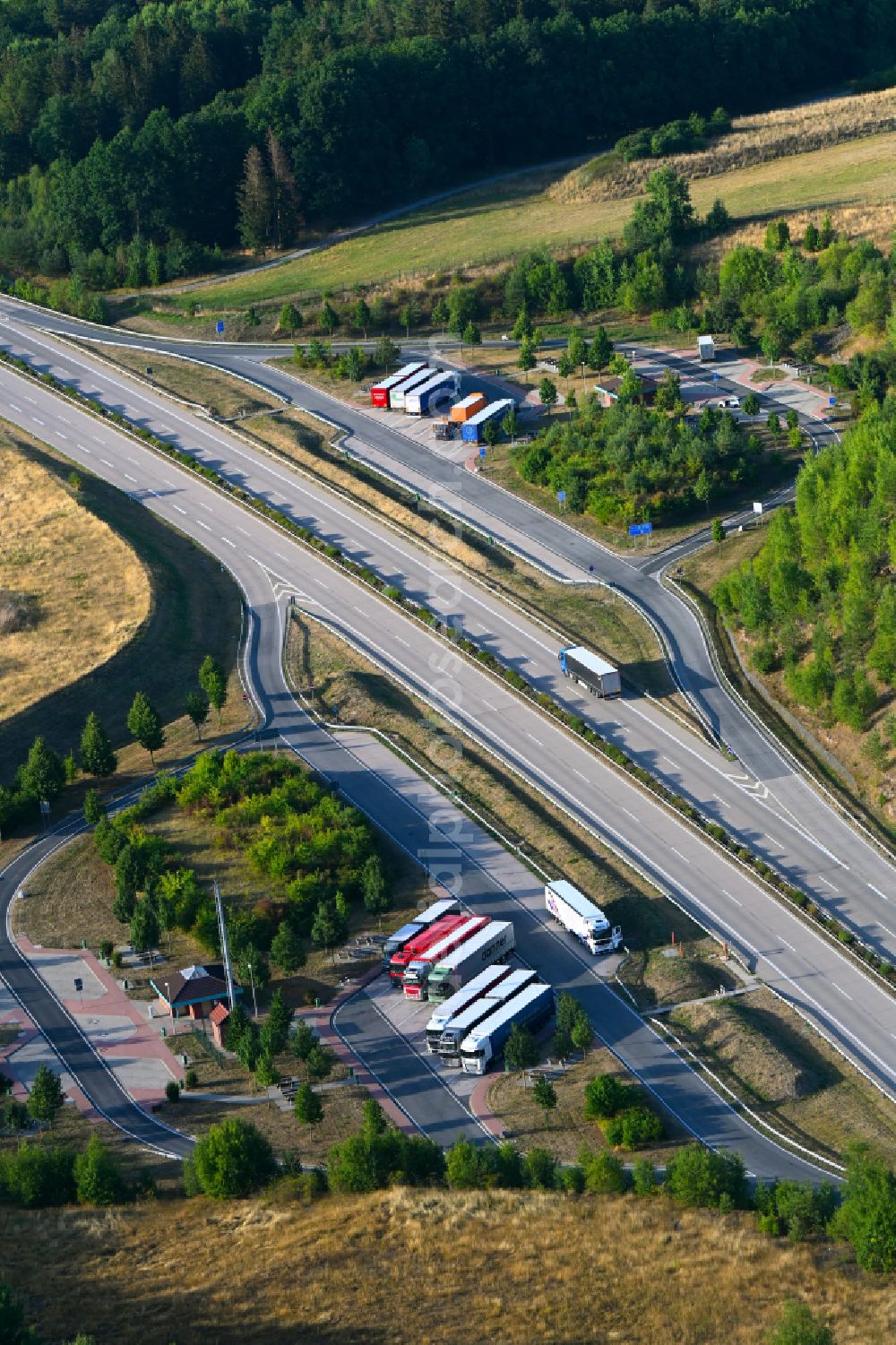 Grabfeld from above - Motorway parking lot and parking area for automobiles with rest area and toilet for short stays on the edge of the course of the BAB A 71 Thueringer Tor in Grabfeld in the state Thuringia, Germany