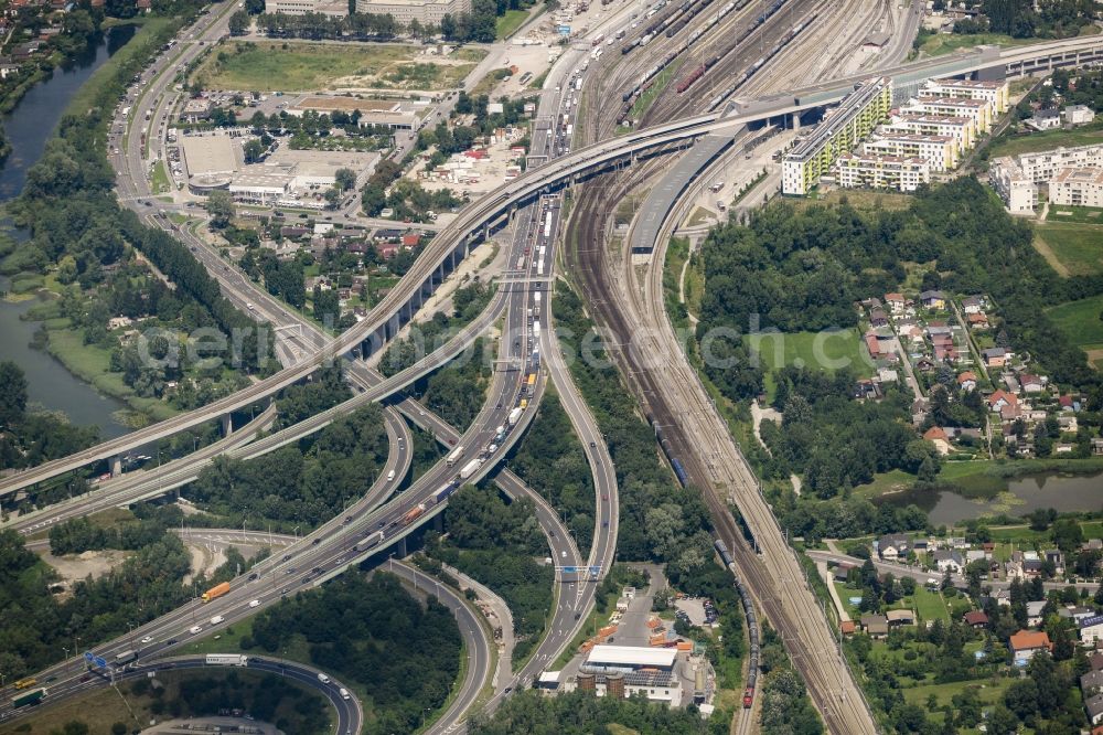 Aerial image Wien - Course of the federal motorway A23 in heavy traffic at the interchange Kaisermuehlen in the Stadlau part of Vienna in Austria. Train station Stadlau is located in the background