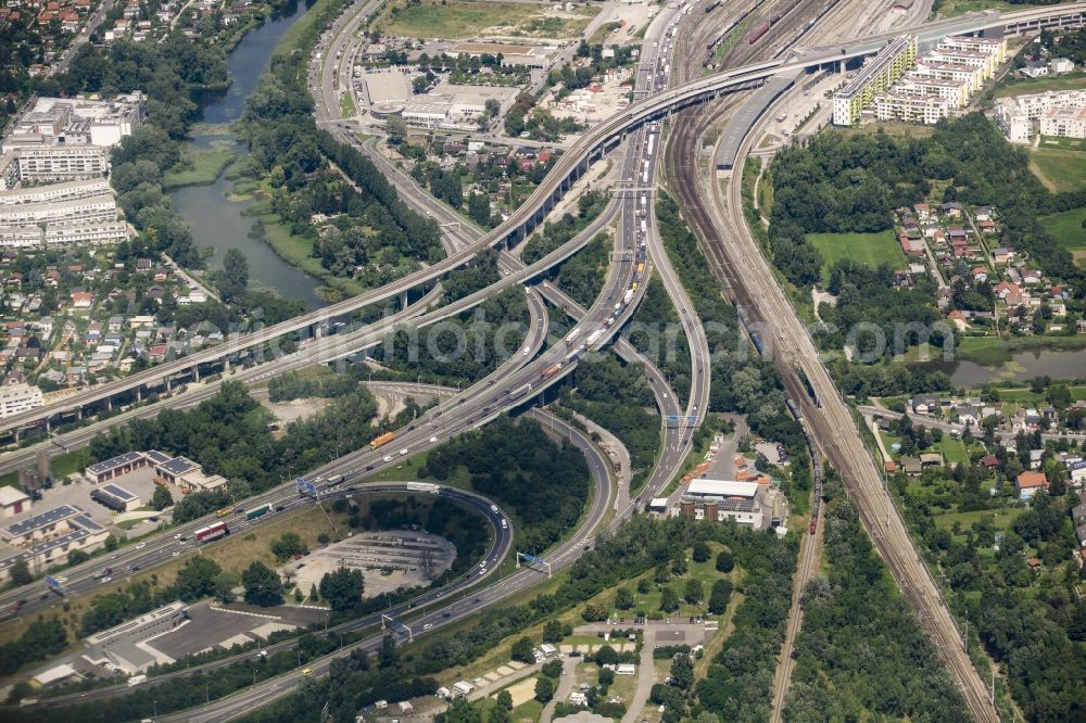 Aerial photograph Wien - Course of the federal motorway A23 in heavy traffic at the interchange Kaisermuehlen in the Stadlau part of Vienna in Austria. Train station Stadlau is located in the background