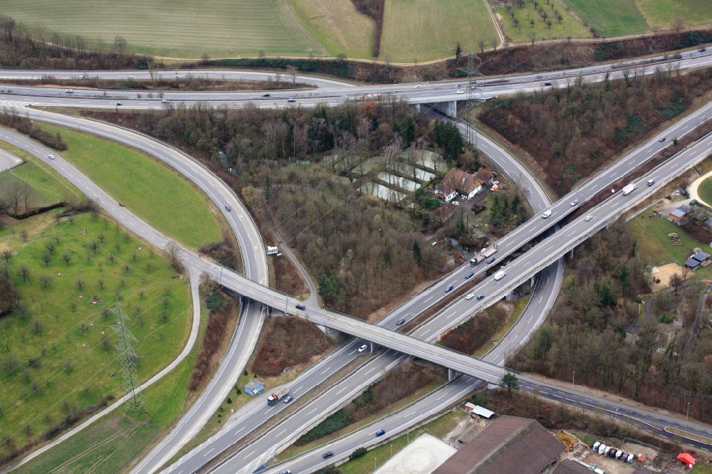 Giebenach from above - Junction and branching of the A2 and A3 in Giebenach in Switzerland. Within the merging point there is a farmhouse and fishponds
