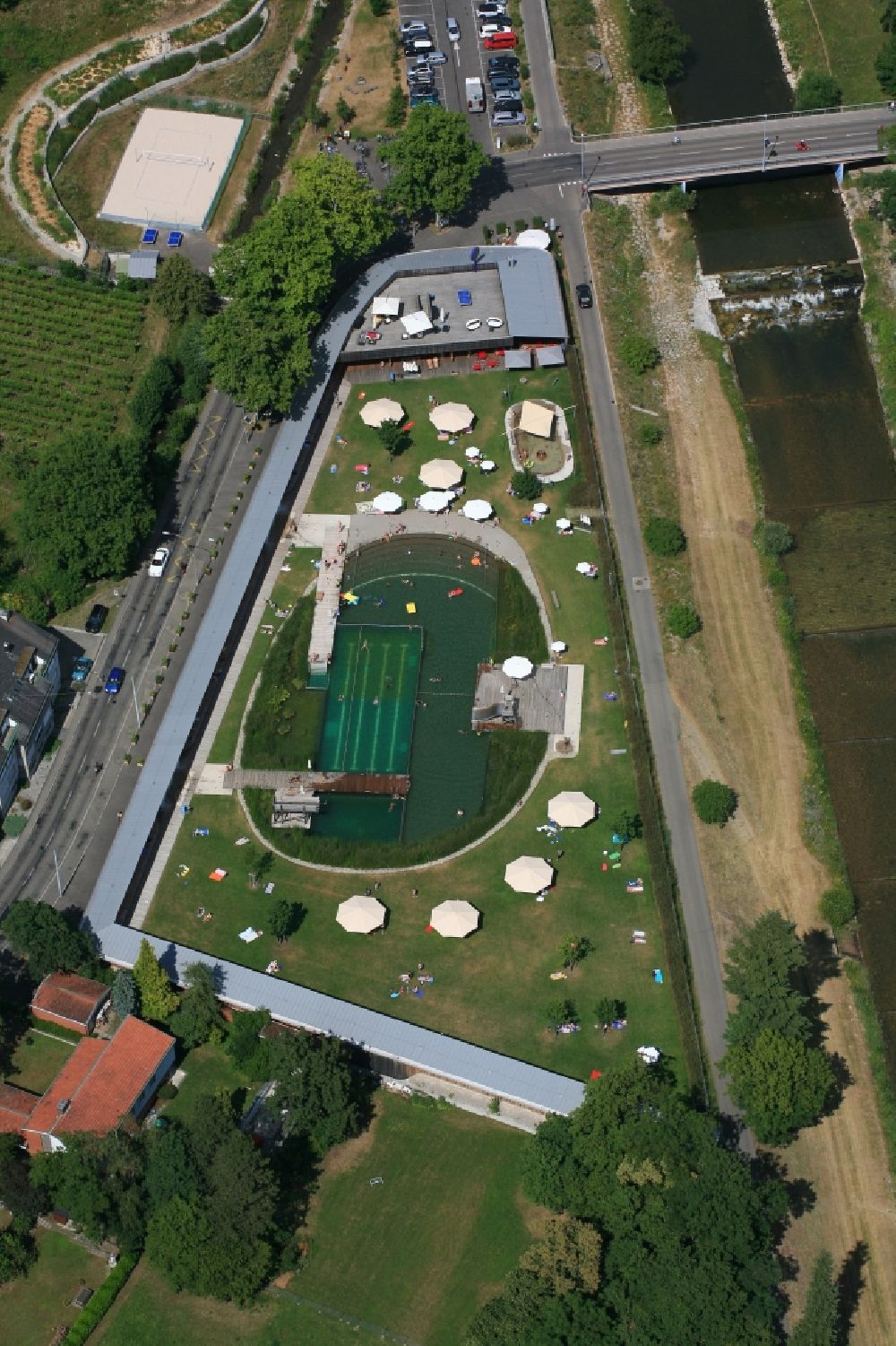 Aerial image Riehen - Bathers on the lawn by the pool of the swimming pool Naturbad Riehen in Riehen in the canton Basel, Switzerland