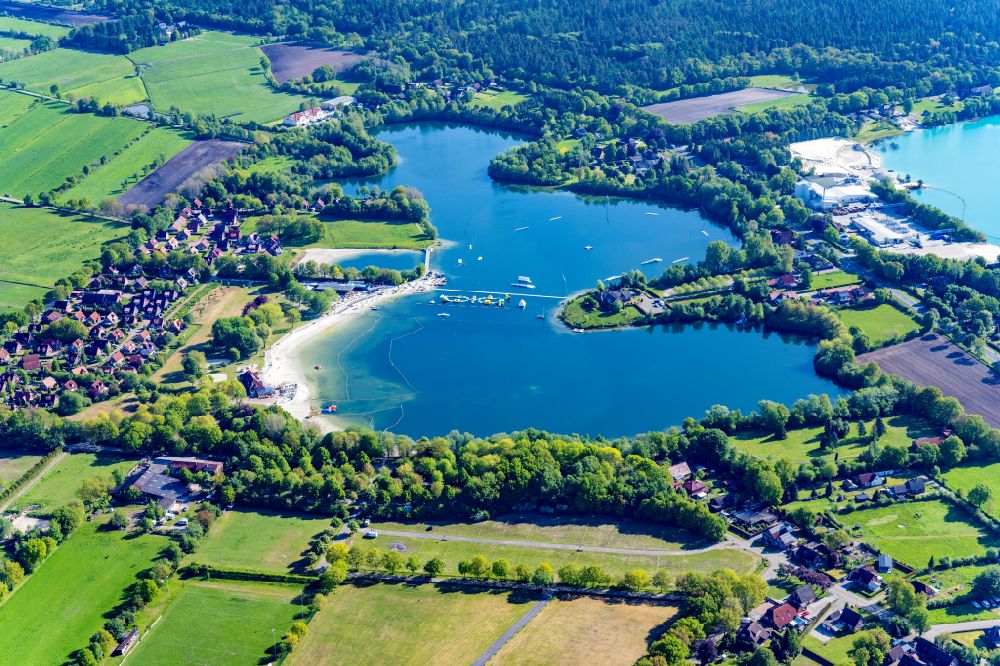 Aerial image Aurich - Lake shore and overburden areas of the quarry lake and gravel open pit Badesee in Aurich in the state Lower Saxony, Germany