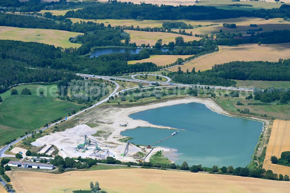 Aerial photograph Zurow - Lake shore and overburden areas of the quarry lake and gravel open pit Heidelberger Sand and Kies GmbH in Zurow in the state Mecklenburg - Western Pomerania, Germany