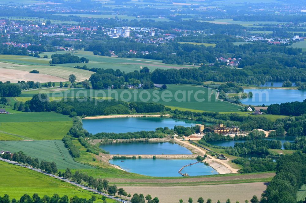 Aerial image Lage - Lake shore and overburden areas of the quarry lake and gravel open pit of Martin Ahle GmbH & Co. KG on street Hoerster Strasse in Lage in the state North Rhine-Westphalia, Germany