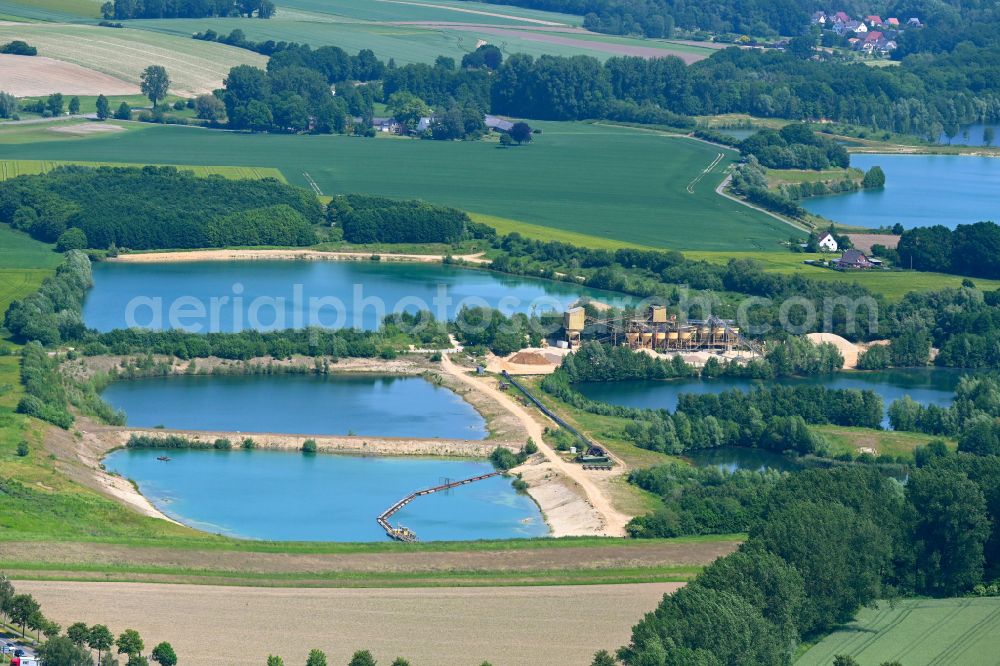 Aerial photograph Lage - Lake shore and overburden areas of the quarry lake and gravel open pit of Martin Ahle GmbH & Co. KG on street Hoerster Strasse in Lage in the state North Rhine-Westphalia, Germany