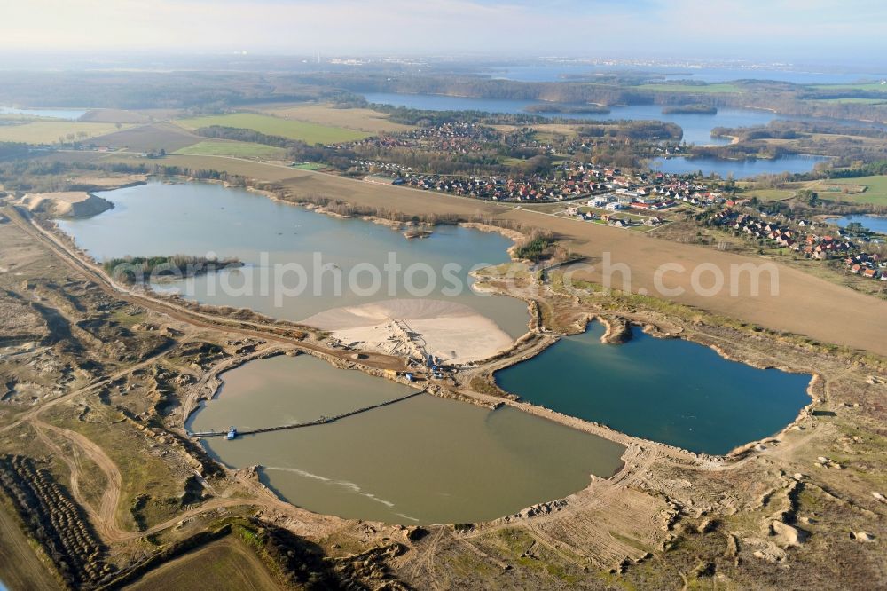 Pinnow from above - Lake shore and overburden areas of the quarry lake and gravel open pit Pinnower Kiessee in Pinnow in the state Mecklenburg - Western Pomerania, Germany