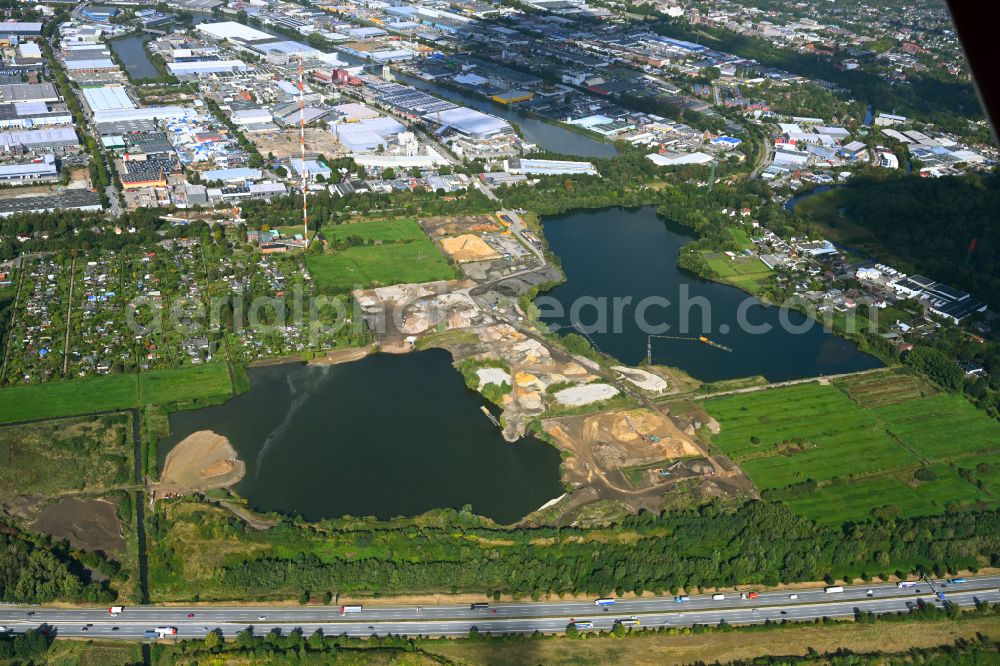 Hamburg from above - Lake shore and overburden areas of the quarry lake and gravel open pit of RBS Kiesgewinnung GmbH & Co. KG in the district Billbrook in Hamburg, Germany