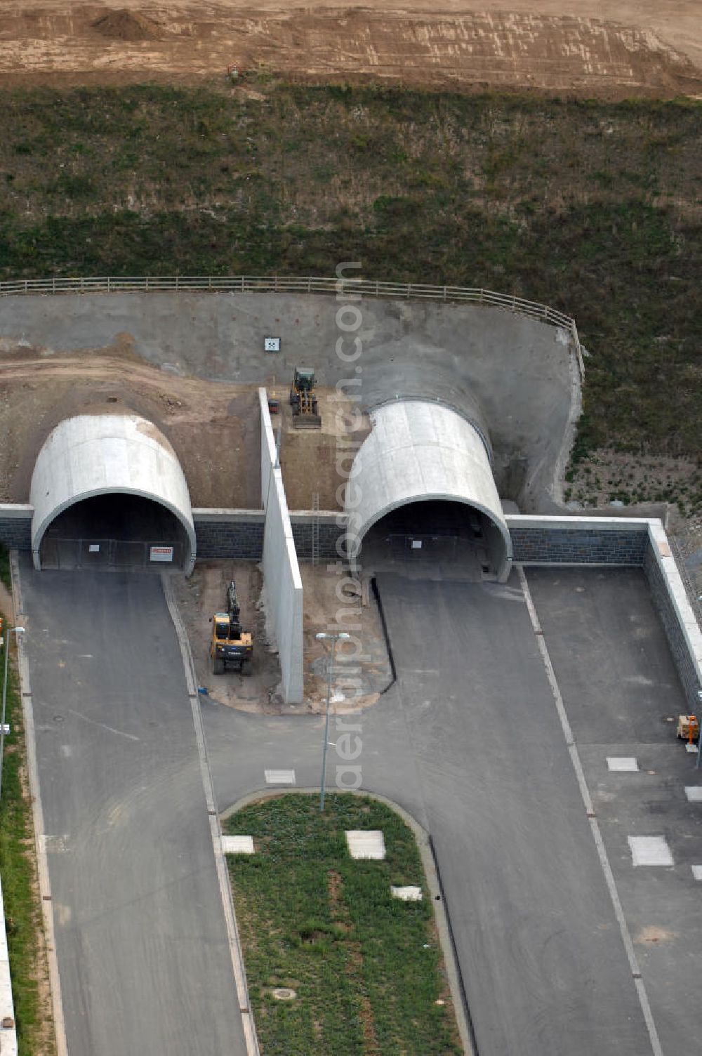 Heldrungen from the bird's eye view: Blick auf den Bau des Schmücketunnels bei Heldrungen in Thüringen. Der Straßentunnel ist ein Teil der Autobahn A71 und unterquert den Höhenzug Schmücke. Der Beginn des Baus war im Jahr 2005. Gebaut wird nach der neuen österreichischen Tunnelbauweise (NÖT), bei der zwei parallele Tunnelröhren entstehen sollen, die jeweils zwei Fahrspuren enthalten. Die maximale Länge des Tunnels beträgt 1729 Meter. Die Baudurchführung übernahm die DEGES. Kontakt DEGES: DEGES, Deutsche Einheit Fernstraßenplanungs- und -bau GmbH, Zimmerstraße 54, 10117 Berlin, Tel. +49(0)30 20243 0, Fax +49(0)30 20243 291, Email: info@deges.de; Kontakt Bauüberwachung: BOL / BÜ Schmücketunnel, Hauptstraße 29, 06577 Oberheldrungen, Tel. +49(0)34673 7823 00, Fax +49(0)34673 7823 99, Email: schmuecketunnel@schuessler-plan.de