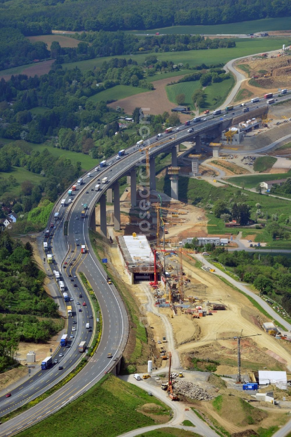 Aerial image Würzburg - Construction work at the Heidingsfeld valley bridge of the federal motorway A3 in the South of Wuerzburg in the state of Bavaria. The bridge spans a valley between two hills. In 2014 it was completely rebuilt by the Arbeitsgemeinschaft Talbruecke Heidingsfeld consisting of Ed. Zueblin AG, Direktion Brueckenbau Bereich Sued Ost und Donges Steeltec