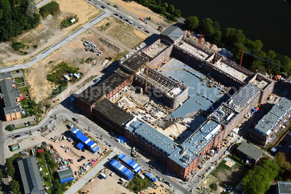 Aerial image Berlin - Reconstruction and expansion - construction site of the buildings and halls of the old REWATEX laundry in the district of Spindlersfeld in Berlin, Germany. The Kanton Property development company mbH is building new apartments on the site with the Wasserstadt Spindlersfeld on the listed area