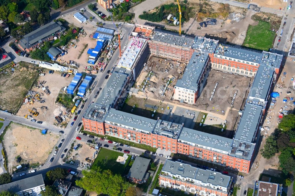 Berlin from above - Reconstruction and expansion - construction site of the buildings and halls of the old REWATEX laundry in the district of Spindlersfeld in Berlin, Germany. The Kanton Property development company mbH is building new apartments on the site with the Wasserstadt Spindlersfeld on the listed area