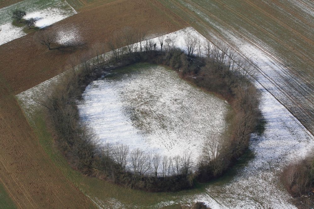 Aerial photograph Maulburg - Overlooking the Tree Circle in Maulburg in Baden-Wuerttemberg. Not the Celts, but remnants of the Second World War have created this tree circle in Maulburg. On the mountain ridge of the Dinkelberg in the last years of the war a radio direction finding station with a large rotating directional antenna was installed. It was used for aircraft positioning. After the war the plant was dismantled, but the circular foundation not completely. Meanwhile bushes and trees have grown as a circular wood from the remains of the foundation
