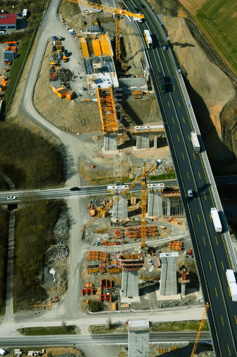 Kürnach from the bird's eye view: Construction site for the new building of Routing and traffic lanes over the highway bridge Kuernachtalbruecke in the motorway A 7 in Kuernach in the state Bavaria, Germany