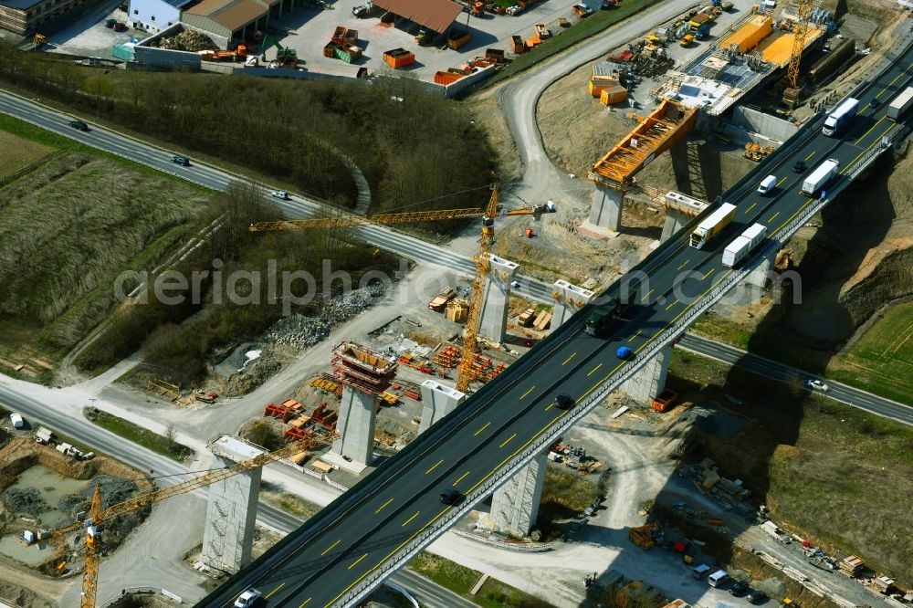 Kürnach from the bird's eye view: Construction site for the new building of Routing and traffic lanes over the highway bridge Kuernachtalbruecke in the motorway A 7 in Kuernach in the state Bavaria, Germany