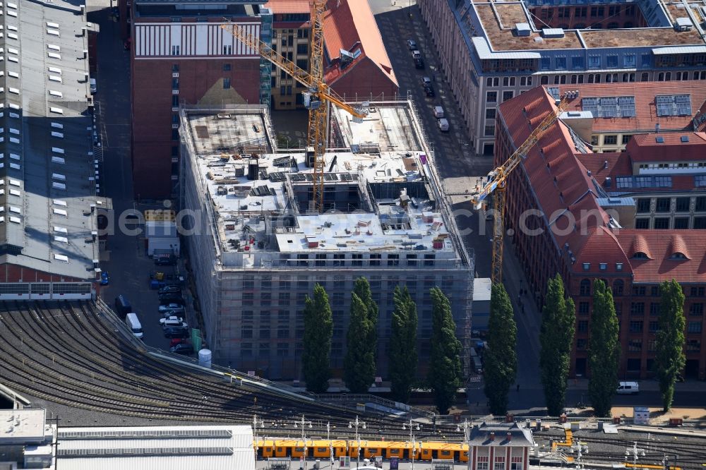 Aerial image Berlin - Construction site on building of the monument protected former Osram respectively Narva company premises Oberbaum City in the district Friedrichshain in Berlin. Here, among many other companies, BASF Services Europe, the German Post Customer Service Center GmbH and Heineken Germany GmbH are located. It is owned by HVB Immobilien AG, which is part of the UniCredit Group
