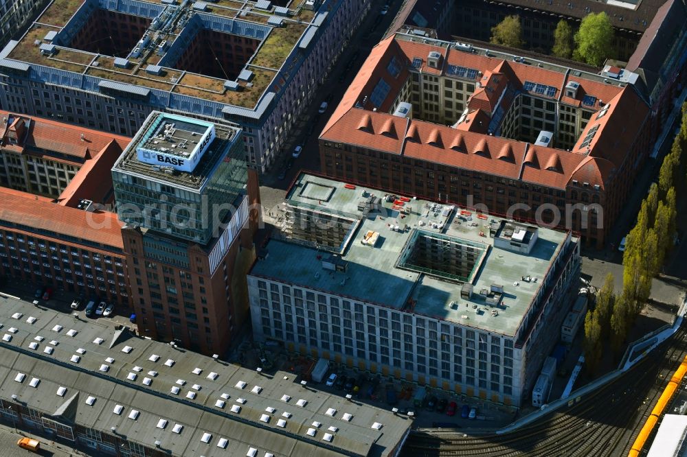 Berlin from the bird's eye view: Construction site on building of the monument protected former Osram respectively Narva company premises Oberbaum City in the district Friedrichshain in Berlin. Here, among many other companies, BASF Services Europe, the German Post Customer Service Center GmbH and Heineken Germany GmbH are located. It is owned by HVB Immobilien AG, which is part of the UniCredit Group