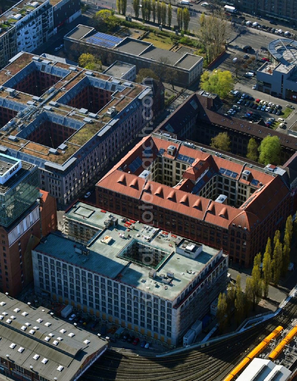 Aerial photograph Berlin - Construction site on building of the monument protected former Osram respectively Narva company premises Oberbaum City in the district Friedrichshain in Berlin. Here, among many other companies, BASF Services Europe, the German Post Customer Service Center GmbH and Heineken Germany GmbH are located. It is owned by HVB Immobilien AG, which is part of the UniCredit Group