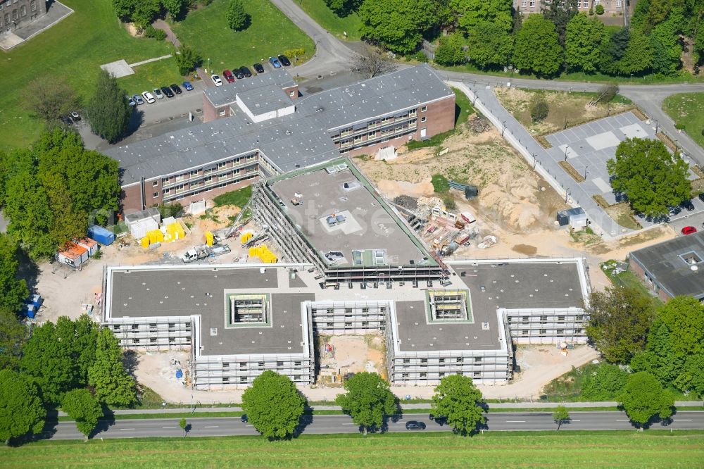 Bedburg-Hau from the bird's eye view: Construction site for a new extension to the hospital grounds LVR-Klinik Bedburg-Hau on Johann-van-Aken-Ring - Gruener Winkel in Bedburg-Hau in the state North Rhine-Westphalia, Germany