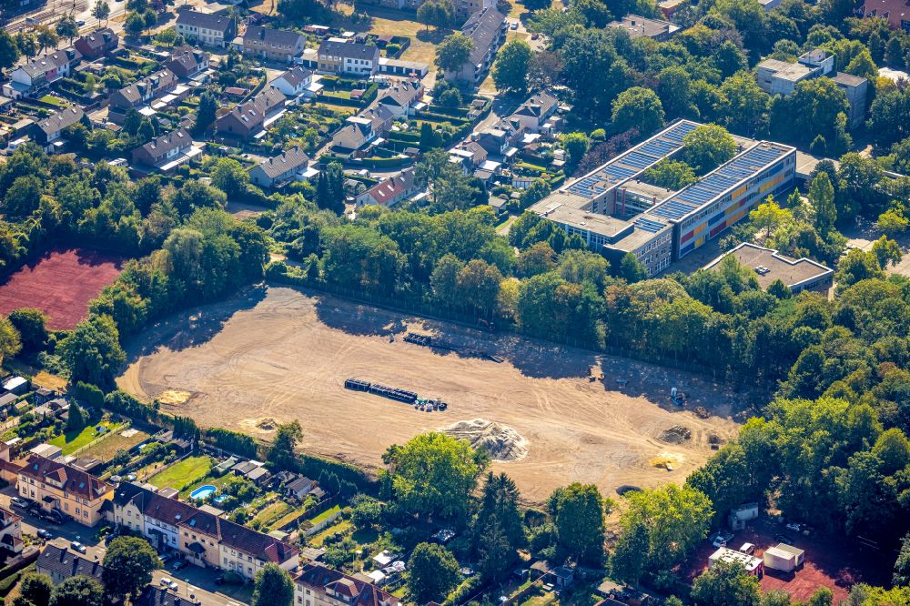 Aerial photograph Duisburg - Construction site with development works and embankments works on the football field Friedrich-Ebert-Strasse overlooking the school building of the Kopernikus-Gymnasium Walsum in the district Vierlinden in Duisburg at Ruhrgebiet in the state North Rhine-Westphalia, Germany