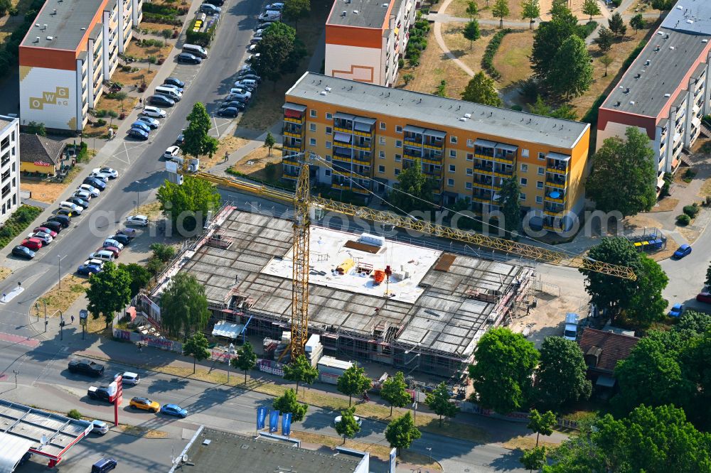 Aerial image Oranienburg - Construction site for the new construction of the building complex of a residential complex with an integrated local supply center MAXNAT on street Berliner Strasse - Walther-Bothe-Strasse in Oranienburg in the state Brandenburg, Germany